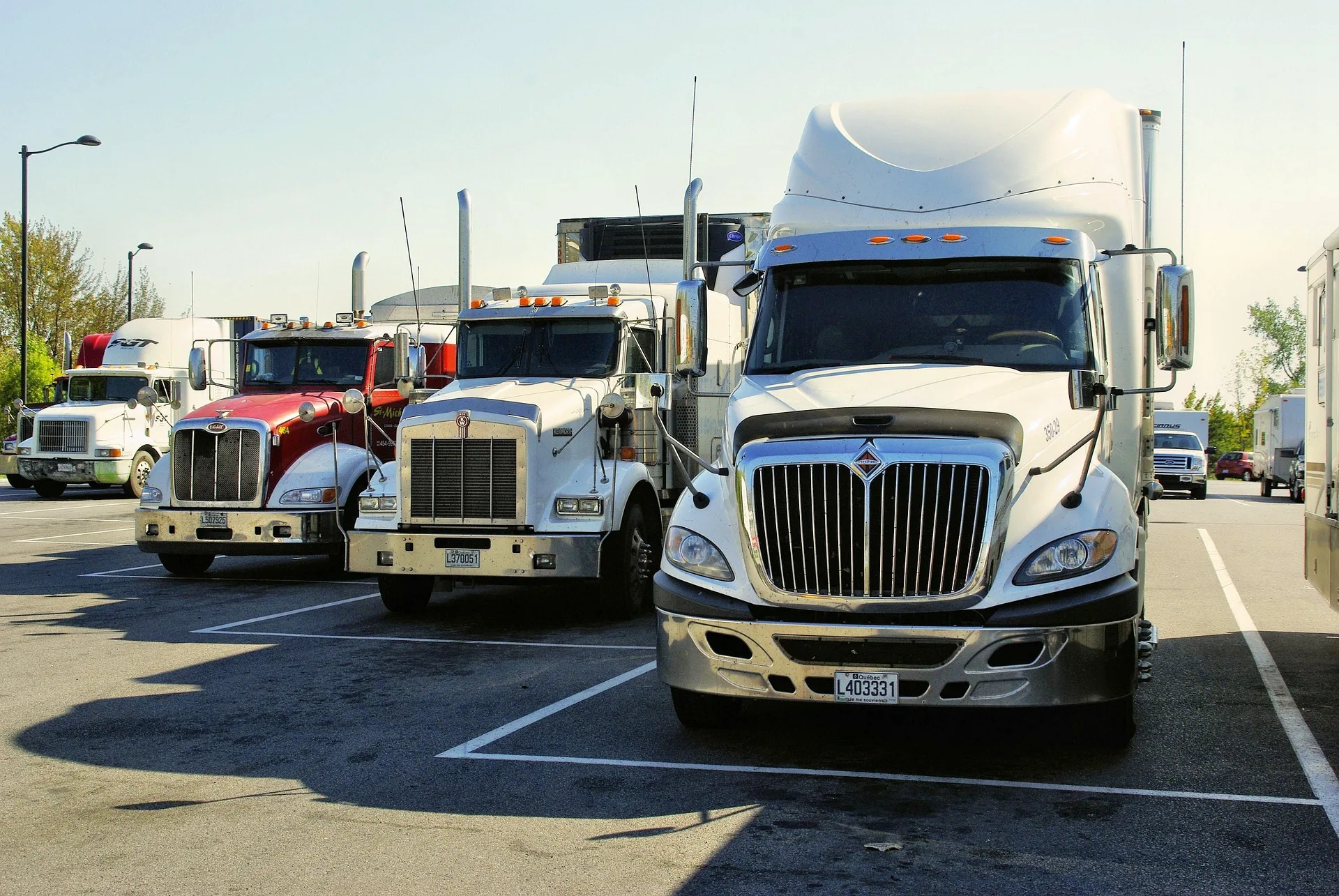 Eric Logistics semi trucks lined up at a rest stop ready for dispatch